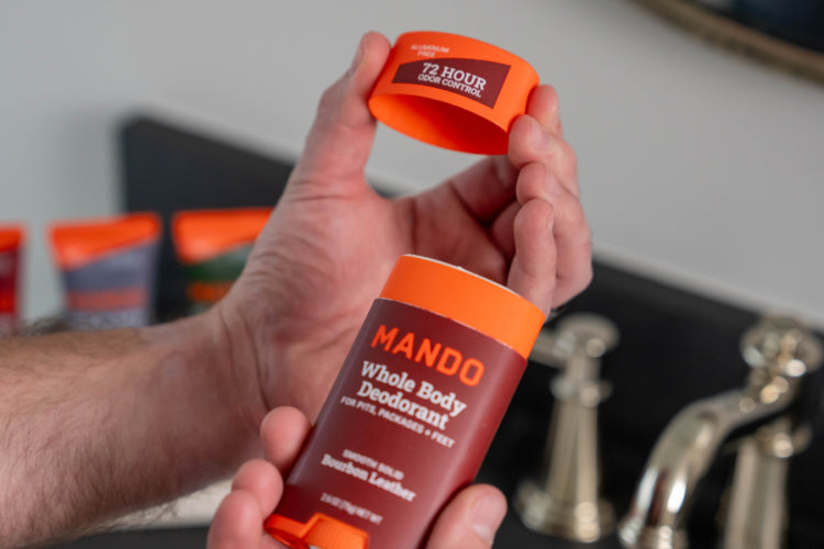 Man holding a Bourbon Leather scented Solid Deodorant stick