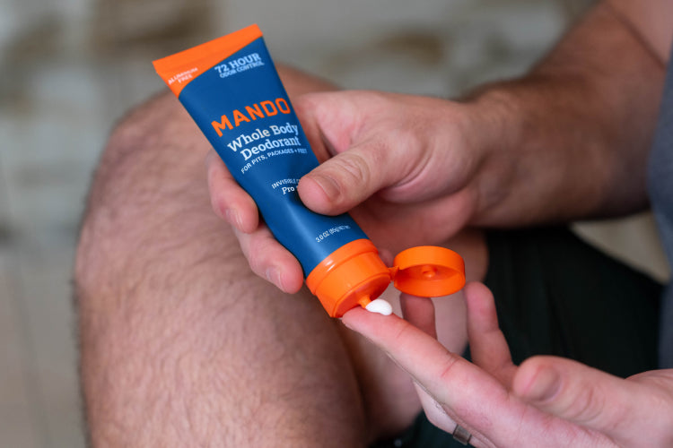 Mando Pro Sport scented Invisible Cream Deodorant being dispensed onto a finger tip