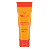 Yellow orange tube of Mando body wash in bourbon leather scent on white background 