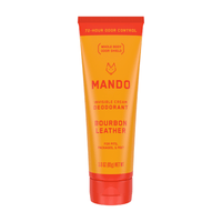 yellow orange tube of Mando Invisible cream deodorant in bourbon leather scent on white background 