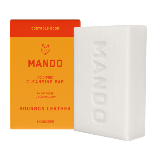 Bar of Mando 4-in-1 acidified cleansing bar outside the box in Bourbon leather scent with white background