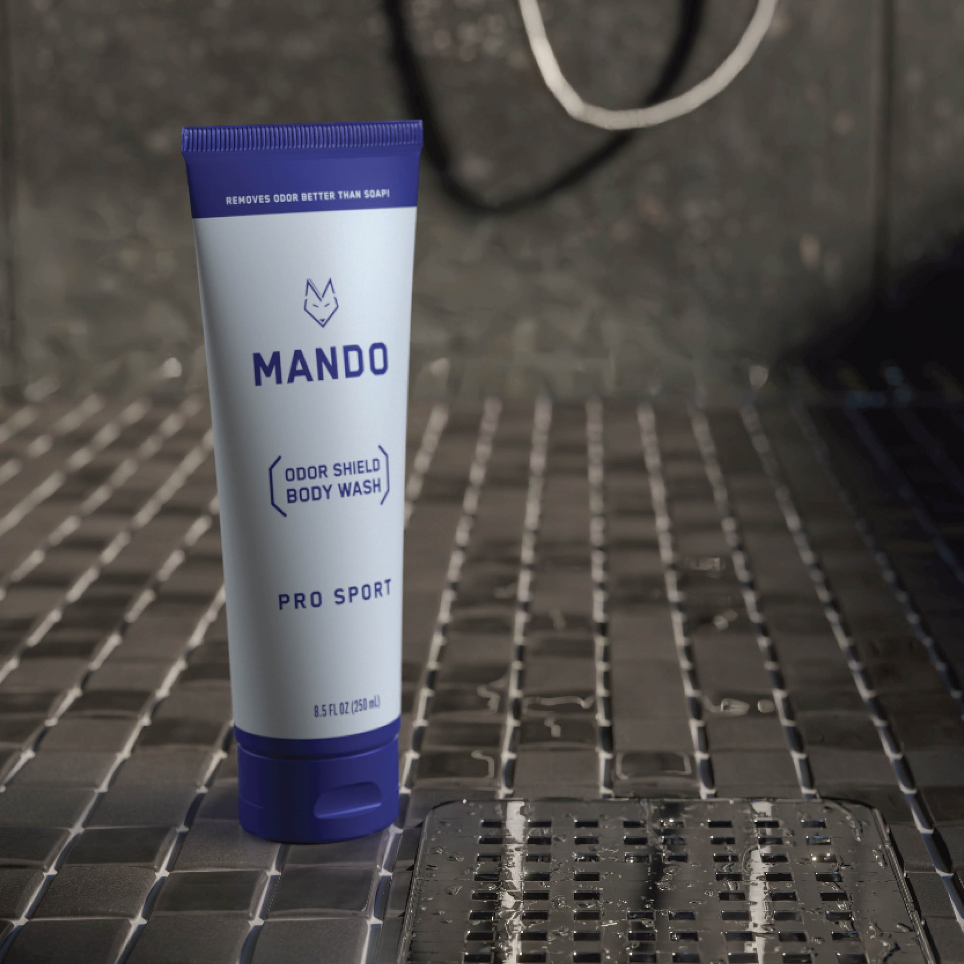 blue tube of Mando body wash placed on shower floor