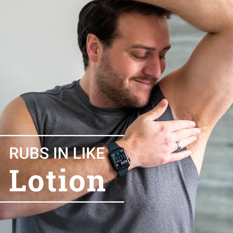 man smiling while applying cream deodorant to armpit with text: rubs in like lotion